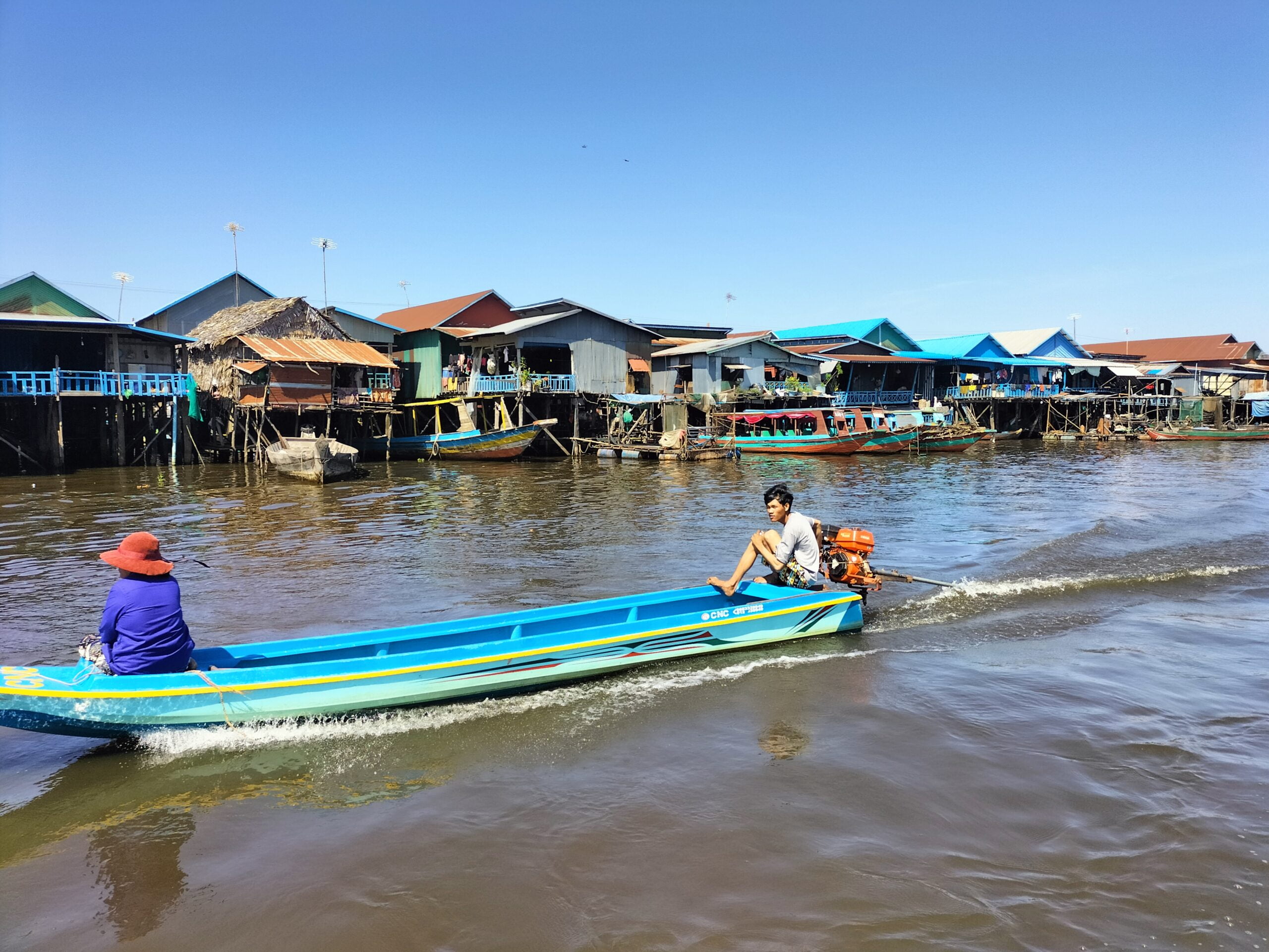 Cambodian fisherman driving the boat through the floating village of Tonle Sap Lake at Kampong Phluk community-04